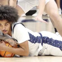 Jacob Nichols dives on the floor to grab a loose ball