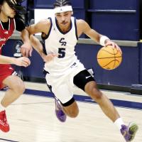 Jacob Nichols (5) drives the basketball around a defender