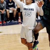 James Reveles shoots a fastbreak layup under a block attempt
