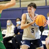 Jay Gililland tries to fake a player before driving the baseline