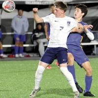Tristan Chandler has his arm pinned down by a Classen SAS defender