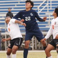 Kenneth Solis uses his elbow to get the leverage on a Guymon player