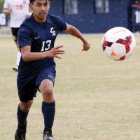Oscar Ortiz runs through the rain to chase down the ball