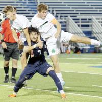 Angel Zarate gets his neck and shoulders squeezed between the arms of two Bishop McGuinness players