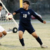 Christian Diaz battles for control of a bouncing ball