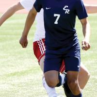 Angel Martinez dribbles up the sidelines past a defender