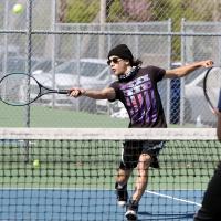 Jacob Guerrero hits a return shot at the net