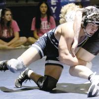 Hunter Davidson leans into a single-leg takedown of Noble’s Knox Bryant