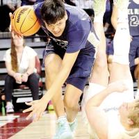 James Reveles tries to keep his balance and control of the basketball