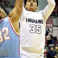 James Reveles shoots a jumper over a Lawton Eisenhower defender 