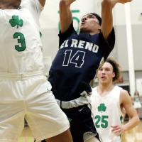 Evan Roman Nose slides between two Bishop McGuinness players