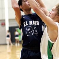 Tre Davis eyes the basket while shooting over a player