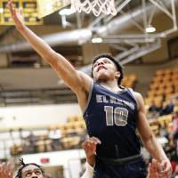 Kaleb Blackwolf jumps over two Midwest City defenders to pull down a rebound