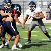 Kaleb Blackwolf waits for a block on a running play
