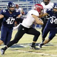 EHS football chasing Duncan Demon
