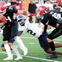 Lathan Pruitt brings down a ball carrier as teammate Diante Palmer reaches out to help
