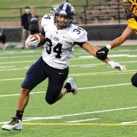 Mikey Devereaux tries to break free of a tackler’s grasp