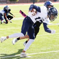 Kobe Null fights his way past a Southeast defender for extra yards