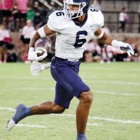 Antawan Grayson (6) looks for a lane to cut back on a sweep play