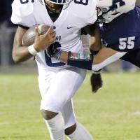 Elijah Fisher tries to elude an Altus tackler