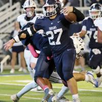 Grant First pushes past a tackler on a run