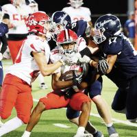 Brad Palmer (1), Rustyn Cook (9) and Avery Mouse (17) combine to bottle up a Carl Albert runner