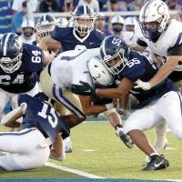 Defenders Eric Parker, Daylin Pruitt, Rustyn Cook and Xavier Elledge combine to make a tackle