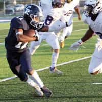 Latin Everheart tries to stiff-arm his way past a tackler