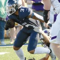 Malachi Nicholson pushes his way past an arm tackle