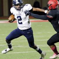 Dorian Plumley pushes off a Duncan defender as he rolls out of the pocket