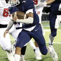 Latin Everheart runs away from two Duncan defenders