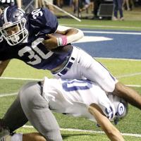 Antawan Grayson stretches for extra yards after having his legs swept