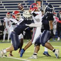 Grant First (27) hits John Marshall quarterback Erick Garcia and forces a fumble that was caught in the air by Dezmond Riley (75)