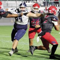 Eric Parker reaches out to grab a John Marshall quarterback