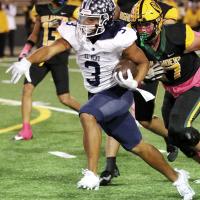 Malachi Nicholson pulls away from a Lawton MacArthur tackler