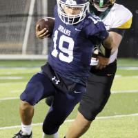Isaac Salgado tries to pull his arm away from a tackle attempt