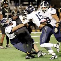 Keaton Dennis and Daylin Pruitt make a tackle