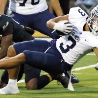 Malachi Nicholson keeps his balance as he falls backward for extra yards