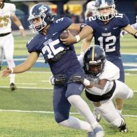 Nate Karty drags a Midwest City tackler for a first down