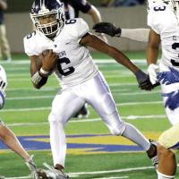 Elijah Fisher cuts back around a block for extra yards