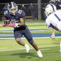 Lathen Pruitt cuts toward the outside as he tries to dodge a Noble tackler