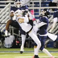 Xzavier Karty jumps into the air as he tries to knock away a pass