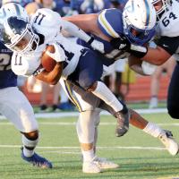 Latin Everheart leaves his feet as he falls forward for extra yards