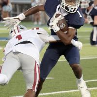 Brad Palmer tries to slip away from a Weatherford tackler