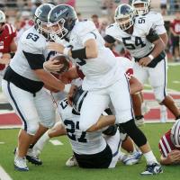Nathan Ashmore (9) cuts to the outside after getting a block from Grant First (27) and Nicholas Mitchum (63)