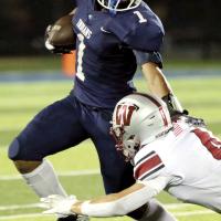 Kaleb Blackwolf uses his hand to push his way past a diving tackle attempt