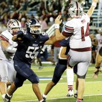 Xzavier Elledge puts pressure up the middle on Weatherford quarterback Stone Chism
