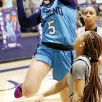 Raegan Bugaj jumps through two defenders on a drive to the basket