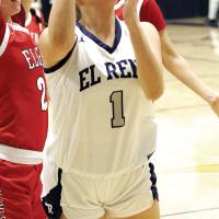 Emmary Elizondo jumps between two Elgin defenders to get off a shot