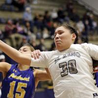 Paige Primeaux has her arm pulled back from a rebound attempt